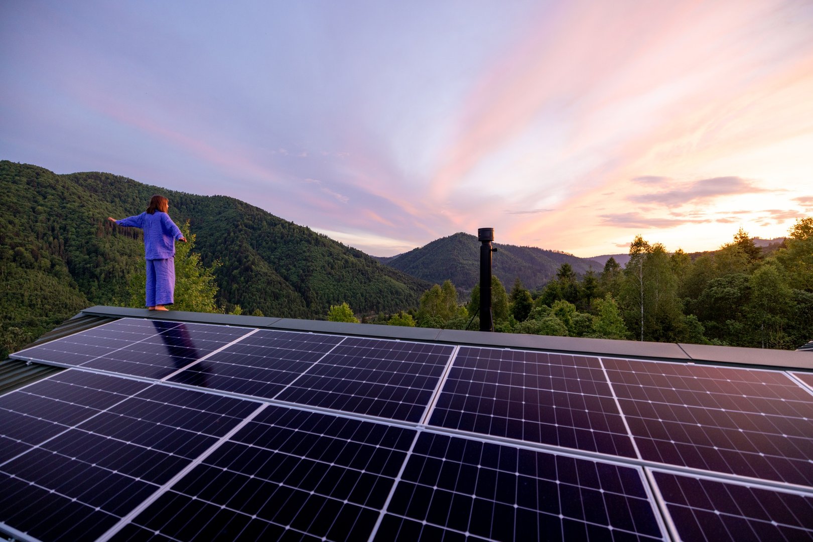 Rooftop with solar panels on house in mountains,
