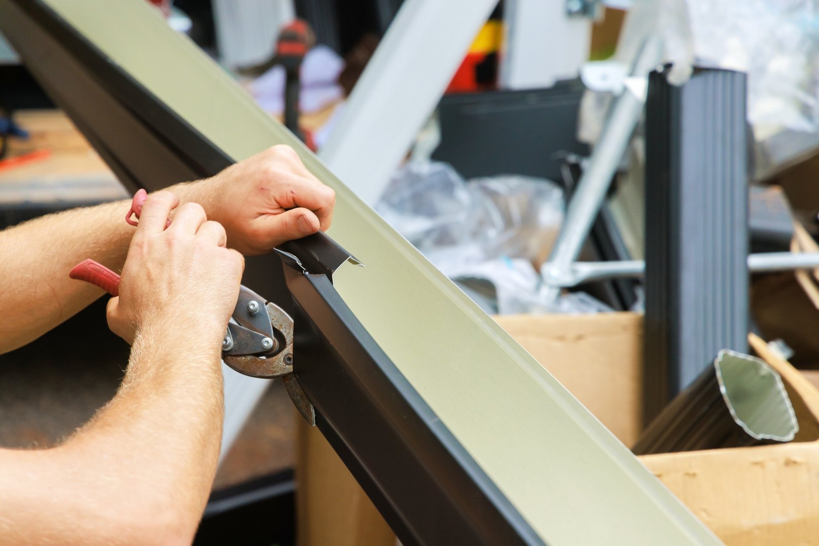 Aluminum rain gutters have been bent by a machine tool then cut with shears to required size