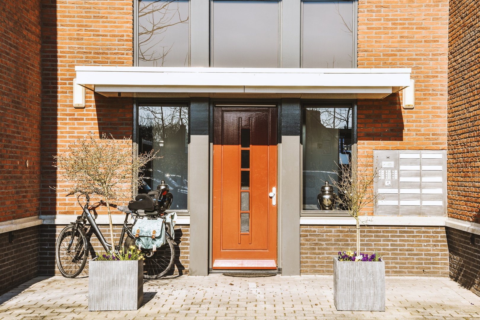 The facade of a brick building with wooden door