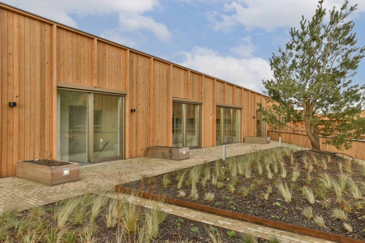 a wooden building with a courtyard in front of it