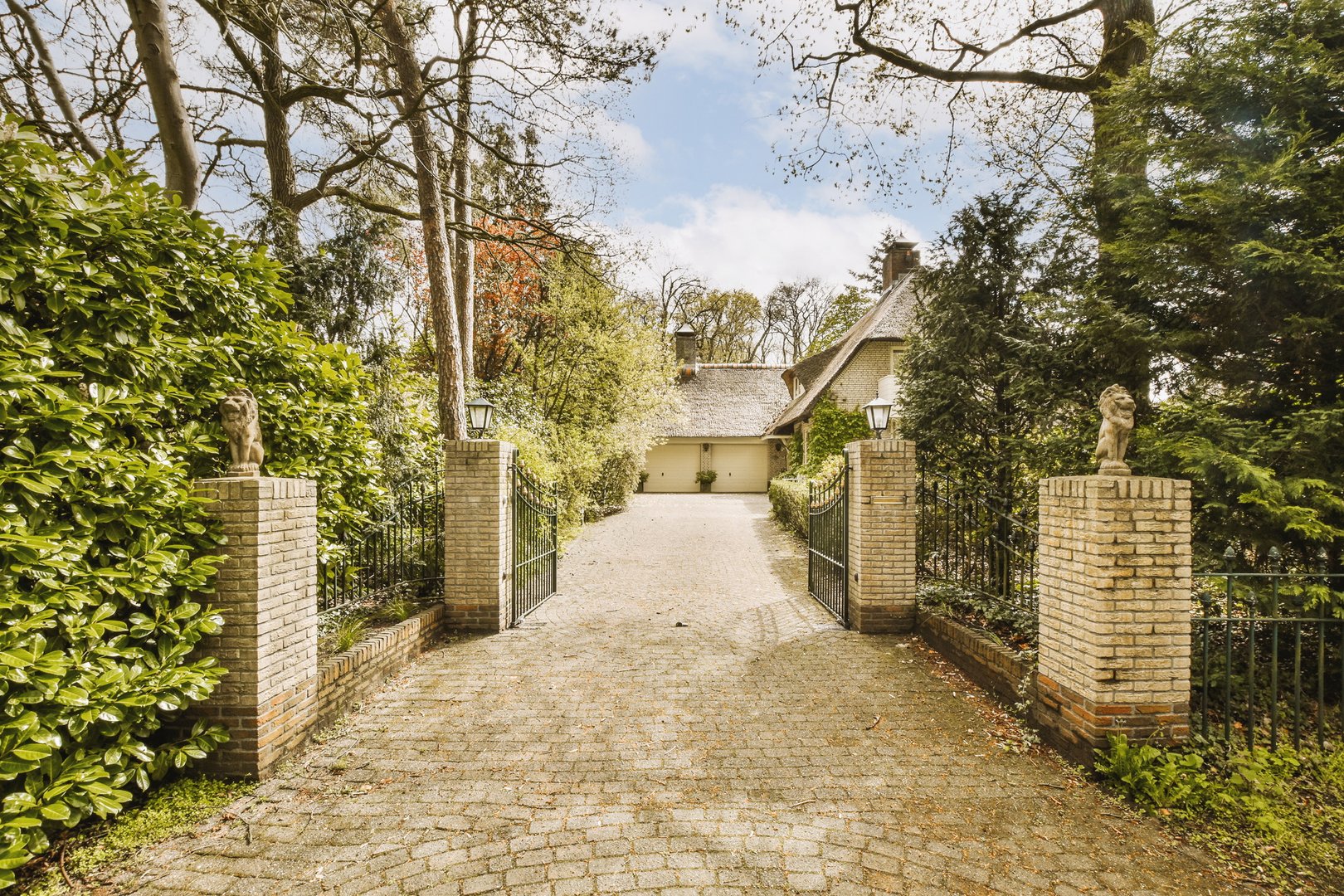 a house with a driveway and a gate and a