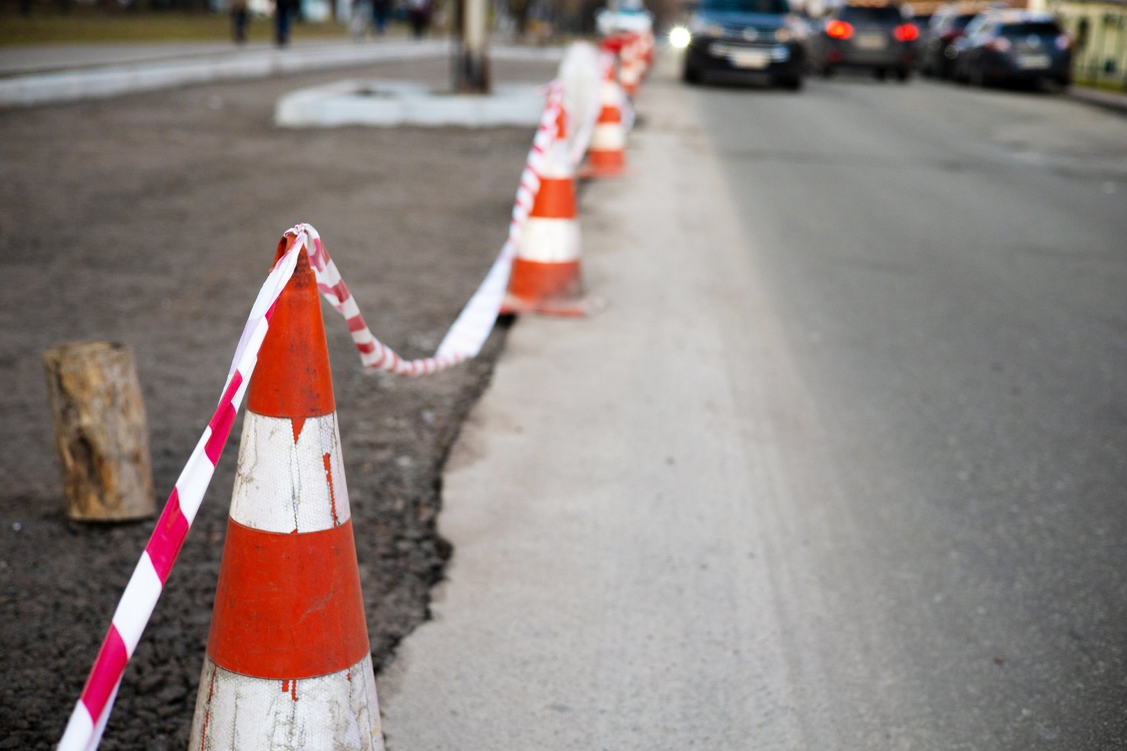 Under construction board sign on the closed road with arrow sign and traffic cone. Caution symbol un