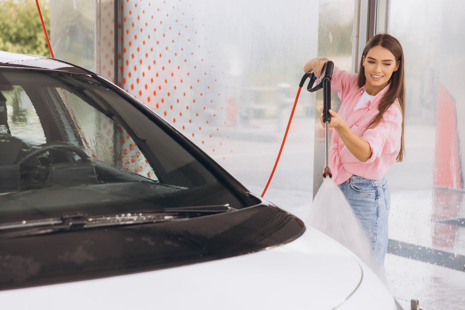 Young Woman Cleaning Car at Self-Service Car Wash