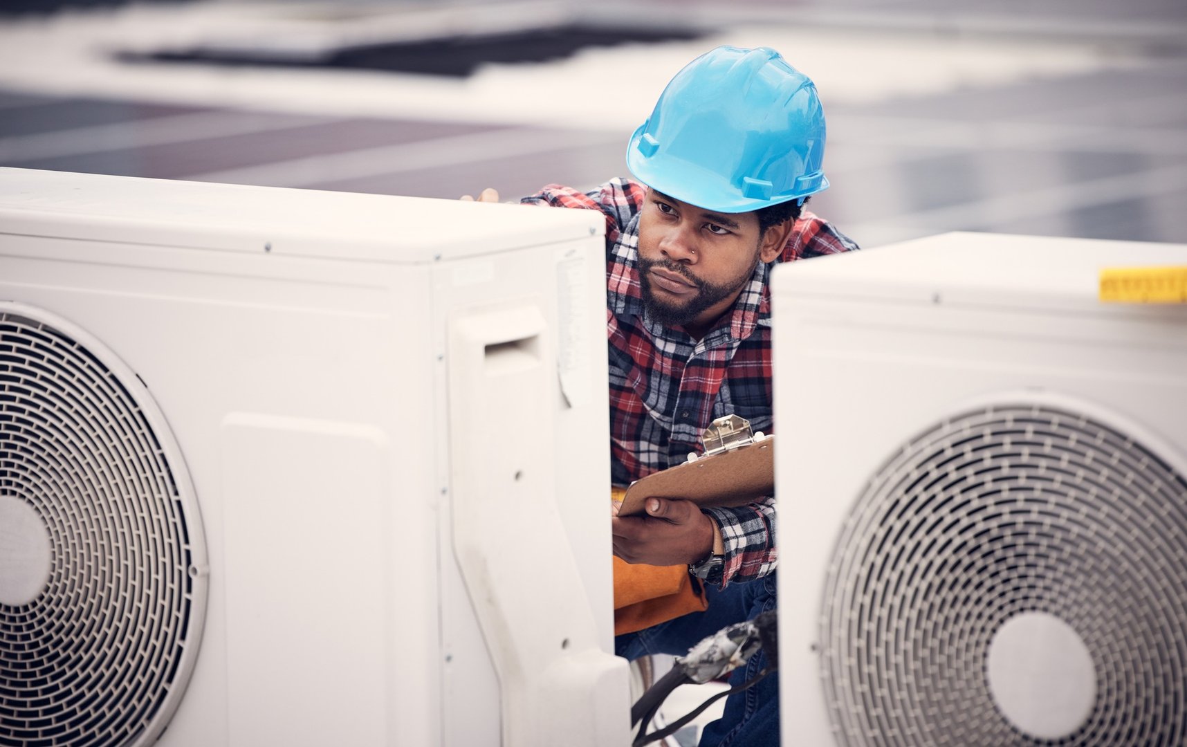 Technician, checklist and air conditioner inspection on rooftop for safety, power and maintenance.