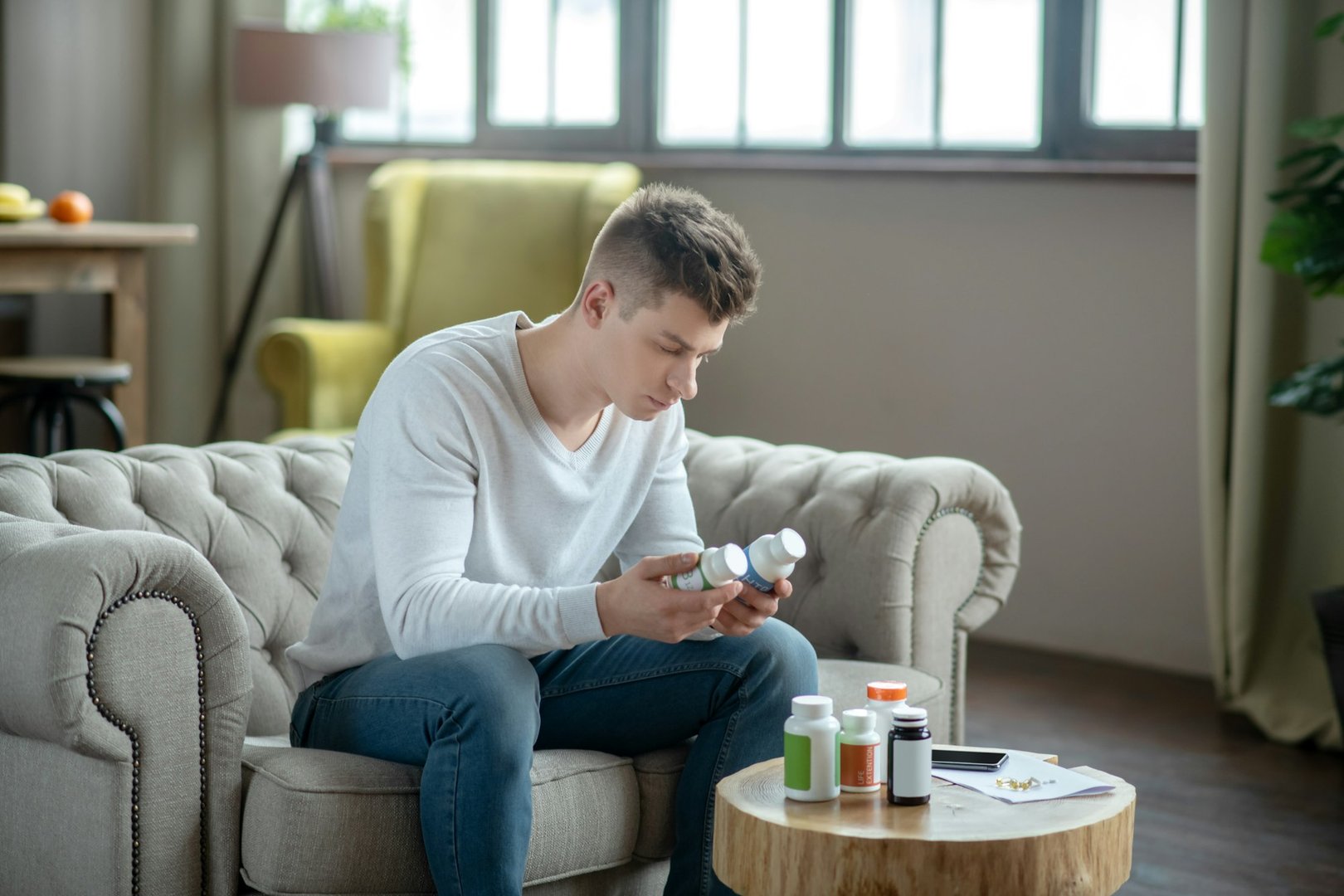 Young man in a white tshirt choosing supplement