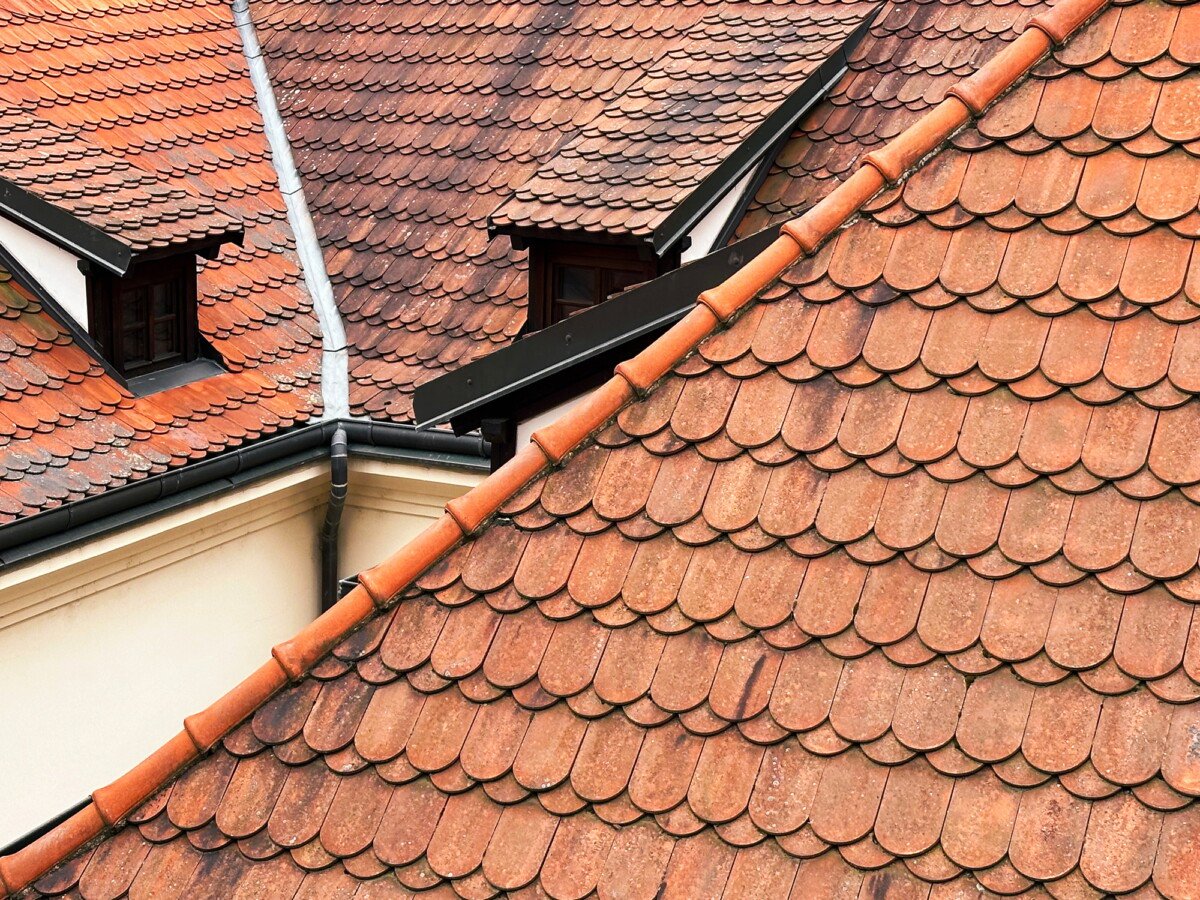 Abstract Geometric Pattern From Roofs of Old Town With Orange Colored Shingle With Chimneys