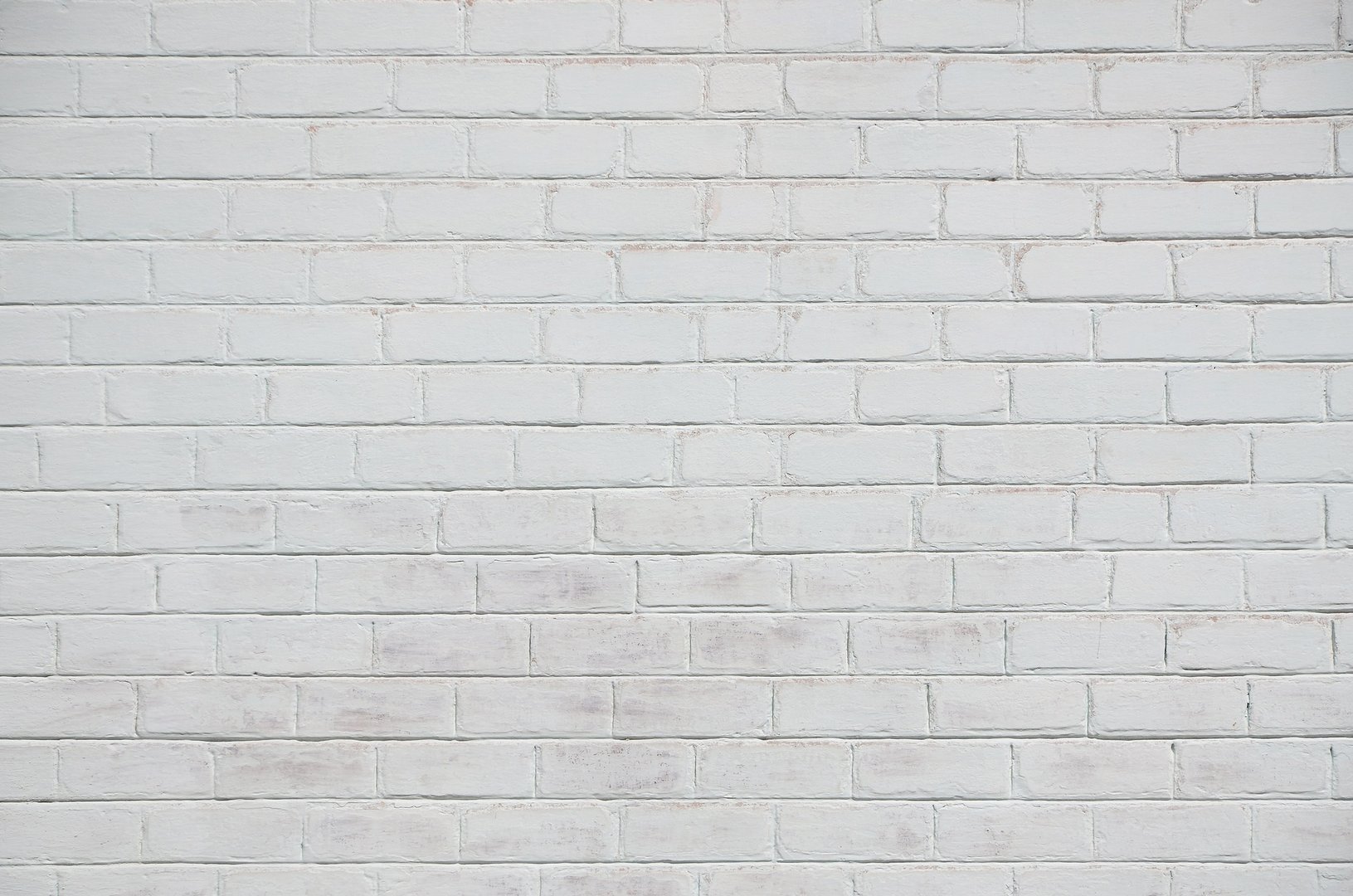 The texture of the brick wall, painted in white