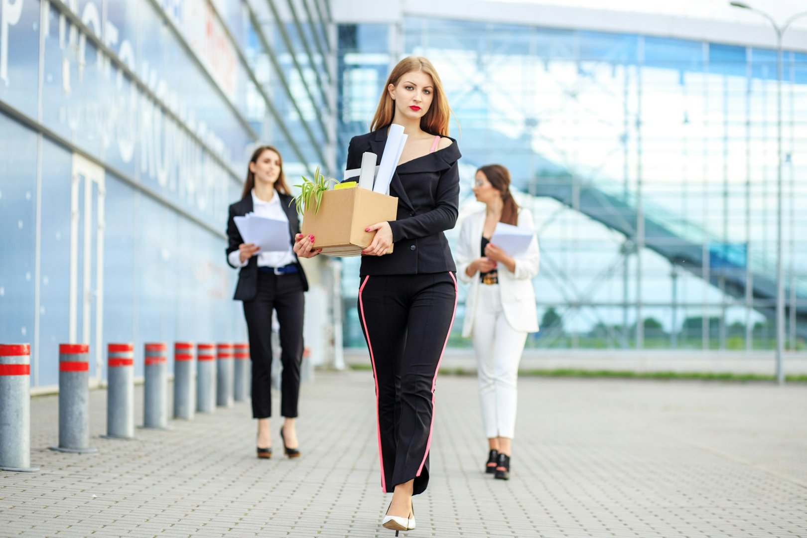 Sad woman fired from a large corporation. Concept for business, unemployment, labor exchange