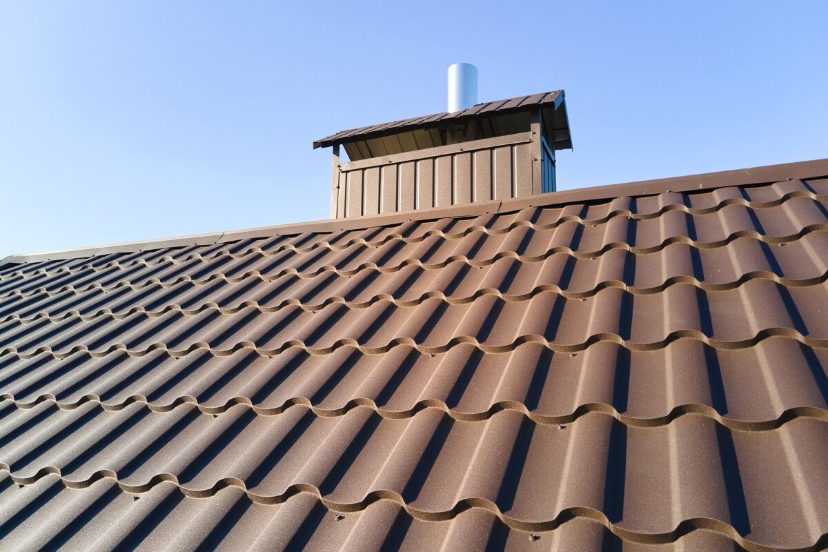 Closeup of house roof top covered with metallic shingles