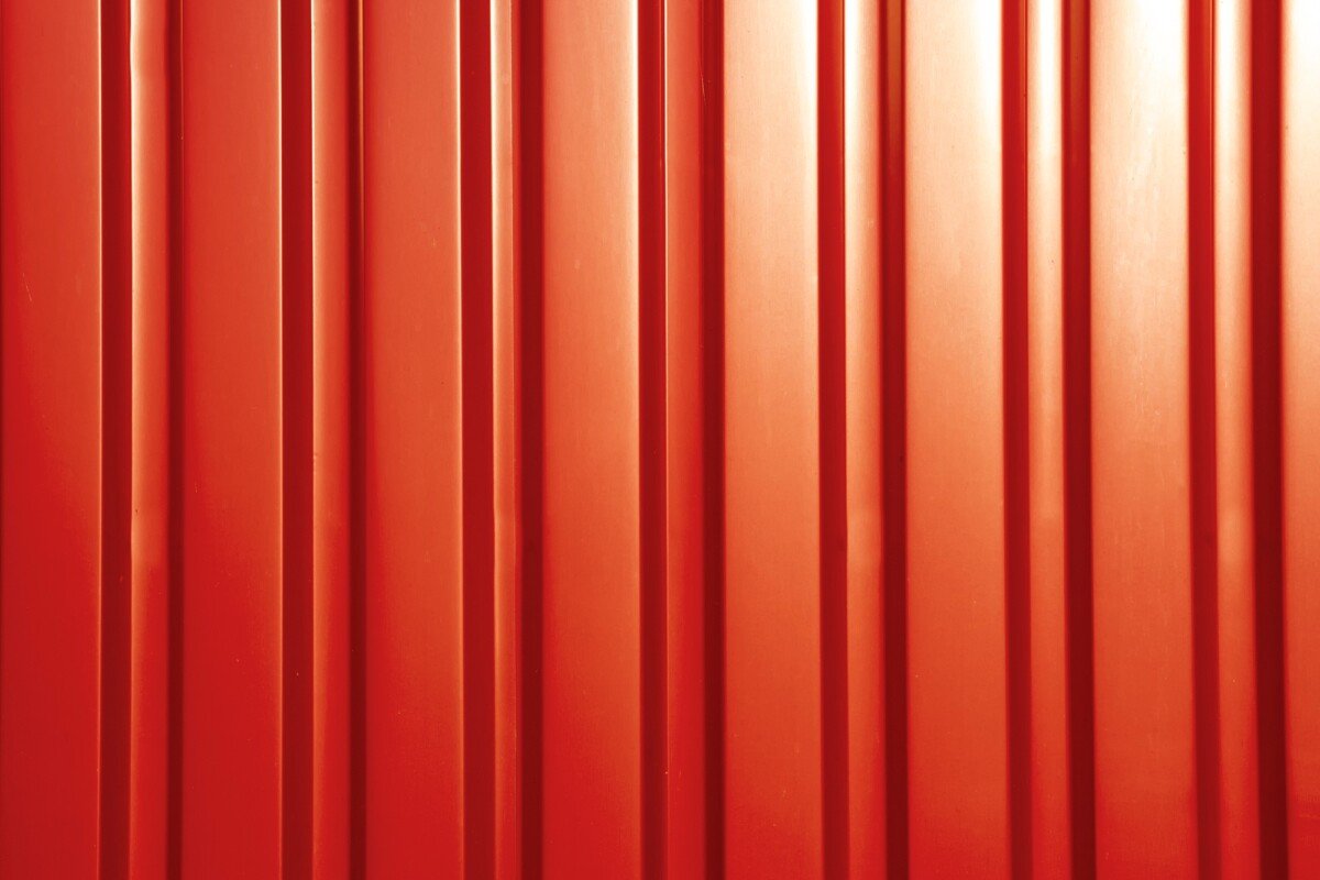 Red sheet metal profile, background. Outdoors of day. Front view.