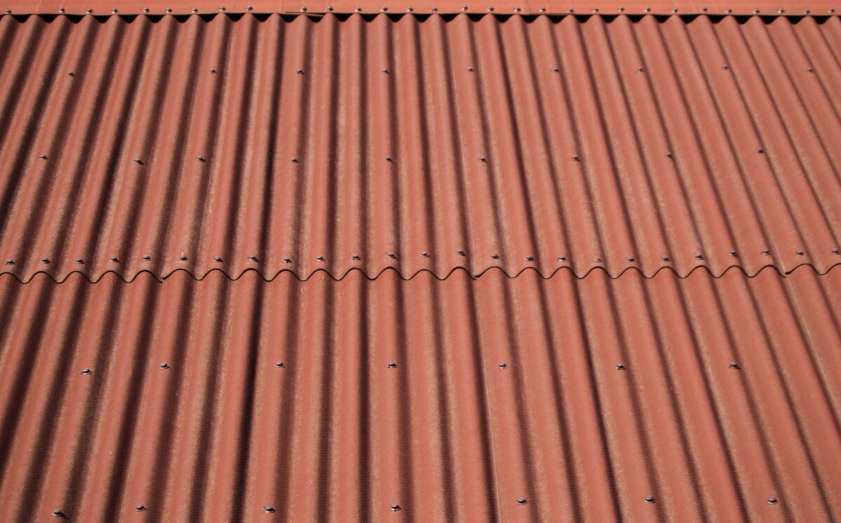 The roof is covered with modern brown siding. Texture Background.