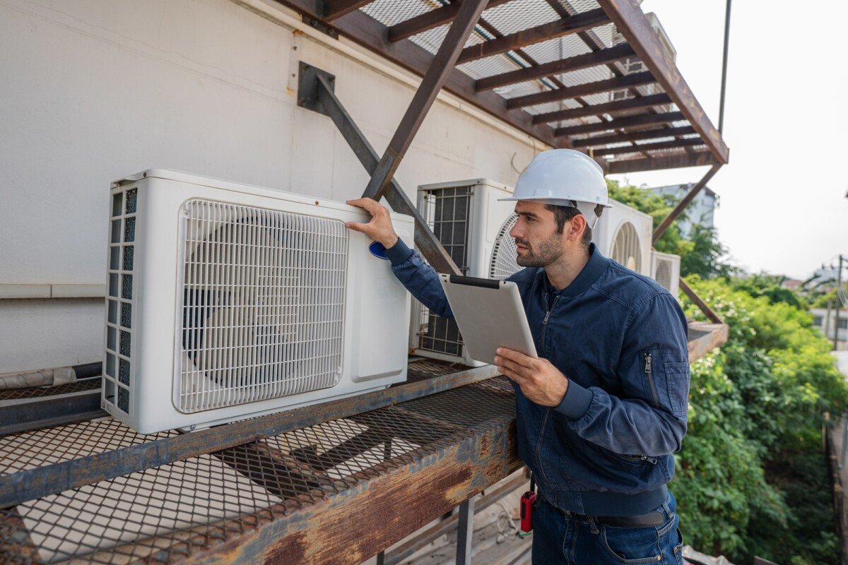 Air conditioner technician checking air conditioner operation.