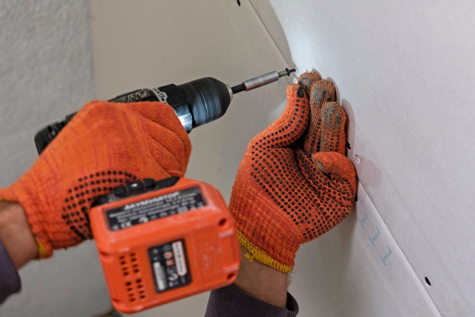 Fastening drywall process in close-up