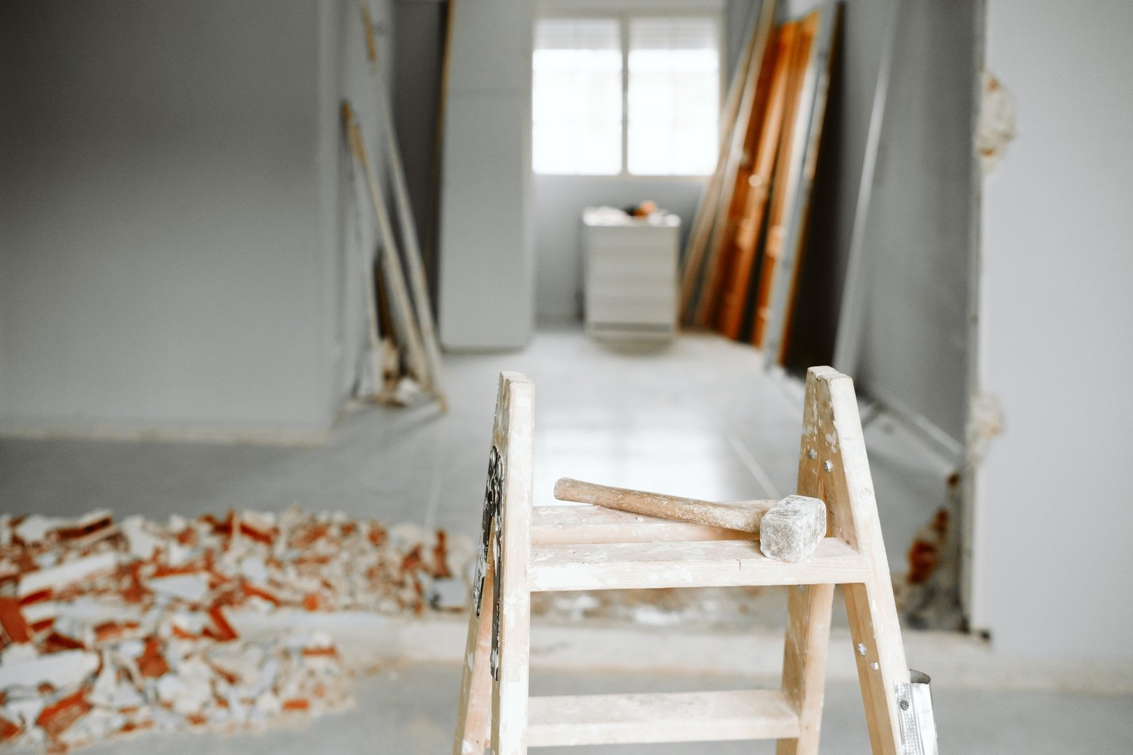ladder, hammer and debris at home construction site. Home renovation