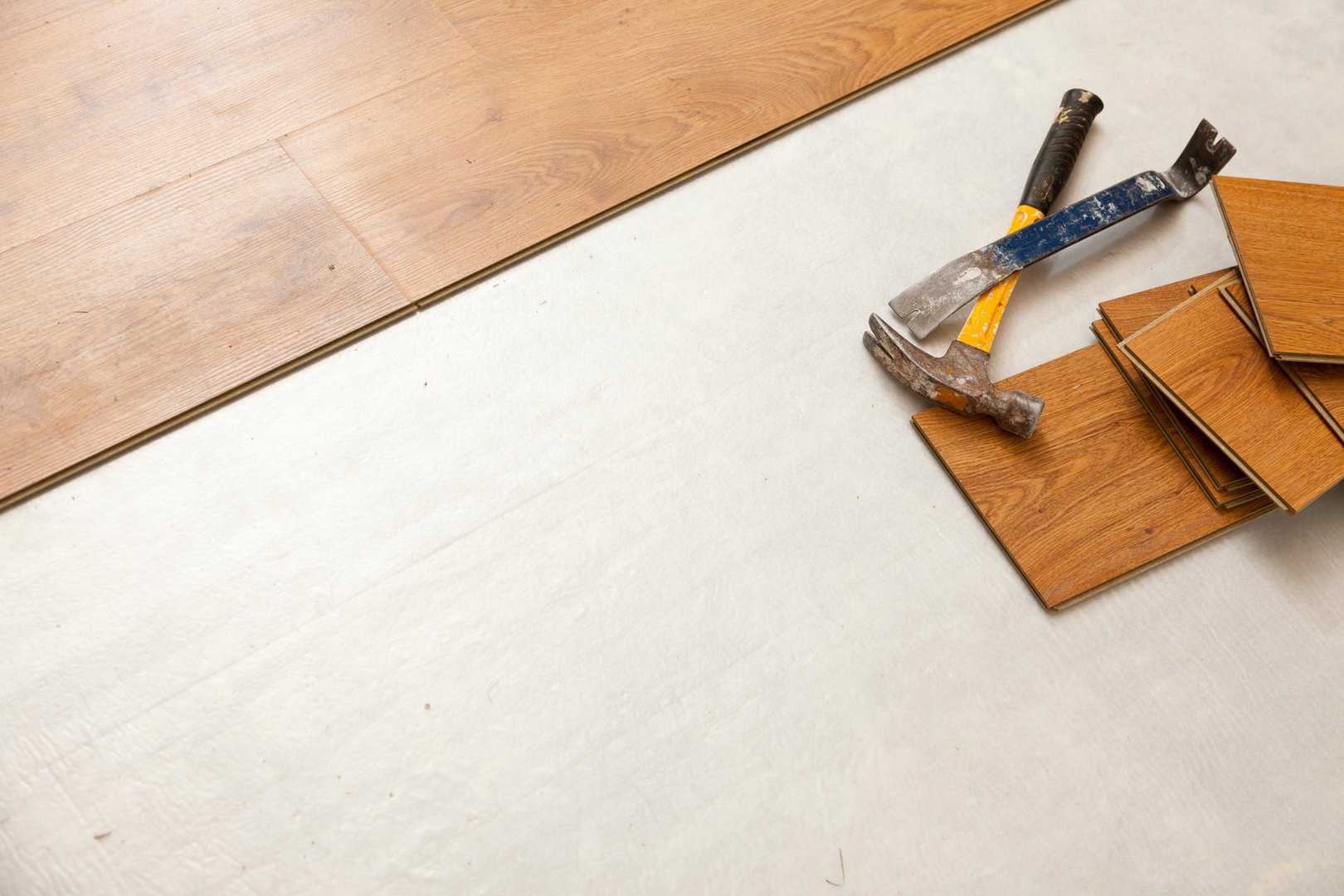 Hammer and Pry Bar with Laminate Flooring Abstract