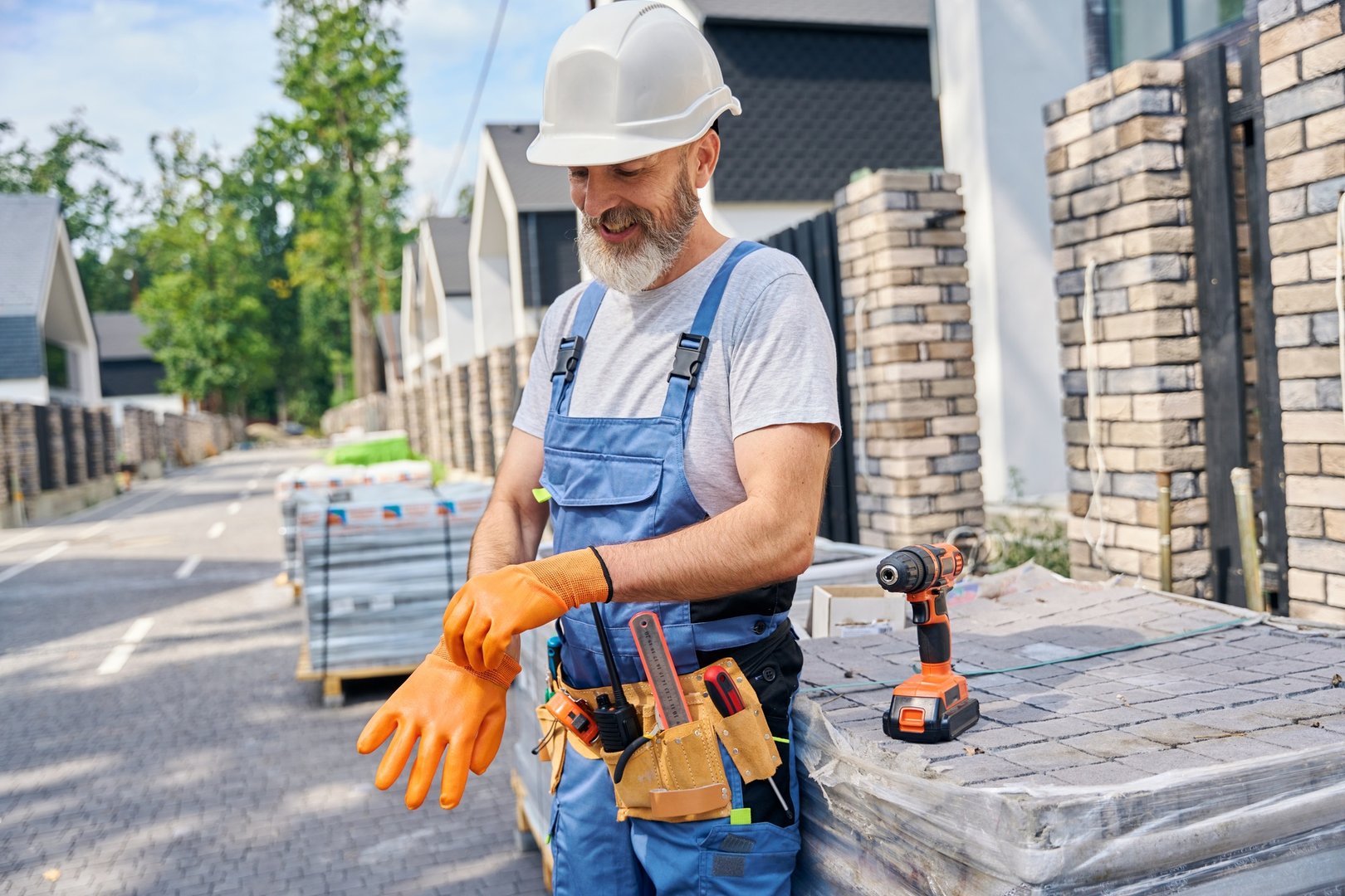 Smiling builder preparing for masonry work on construction site