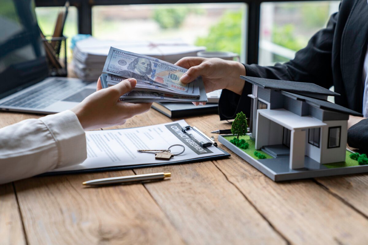 cropped image pay home insurance professional female real estate agent receives a home loan or rent payments from her…