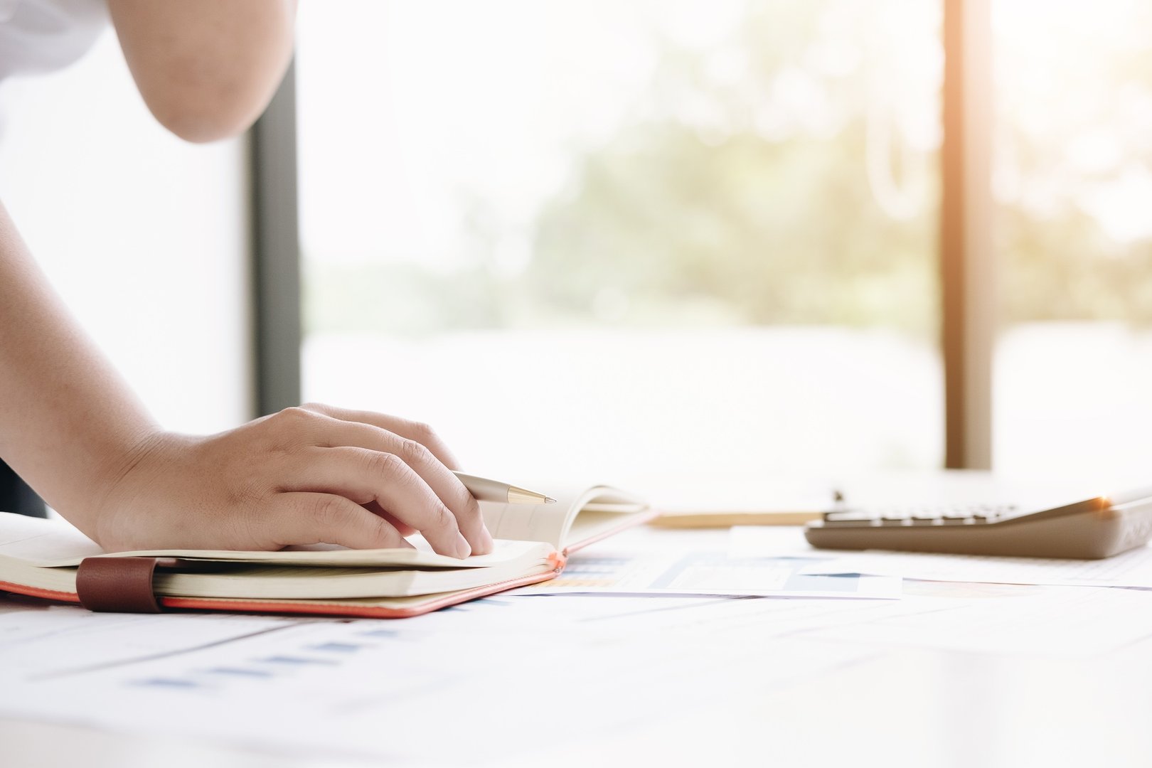 Close up financial inspector hands making report, calculating or checking balance. Home finances