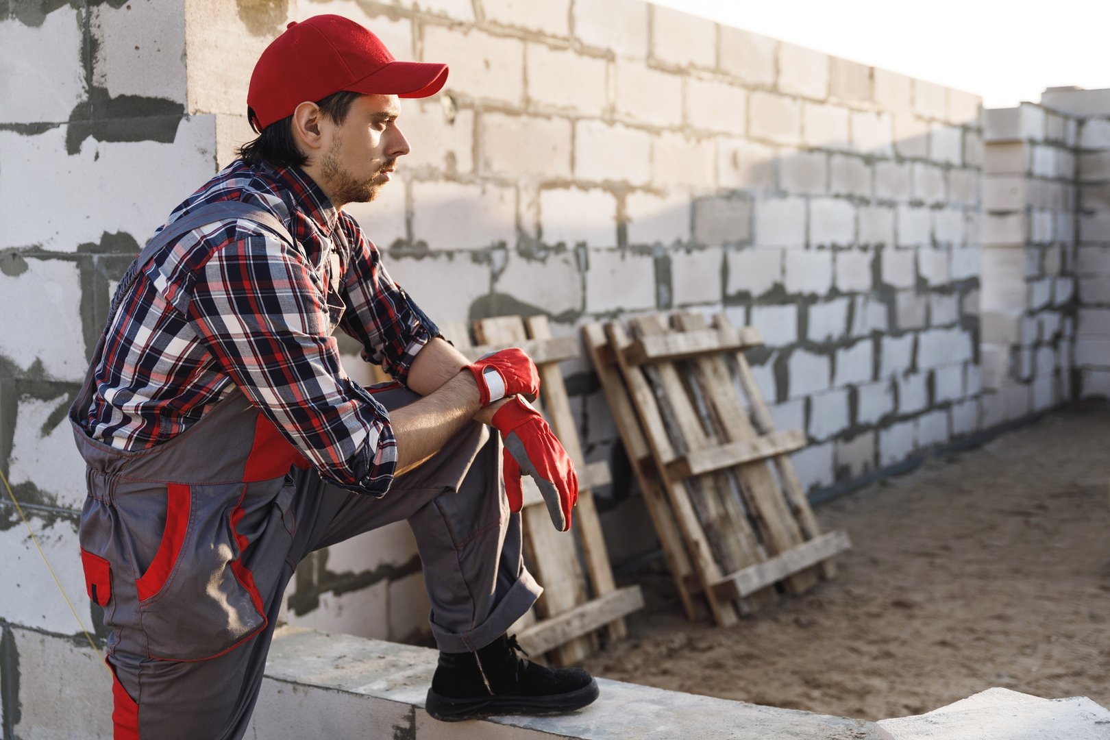 Professional bricklayer man at the construction site