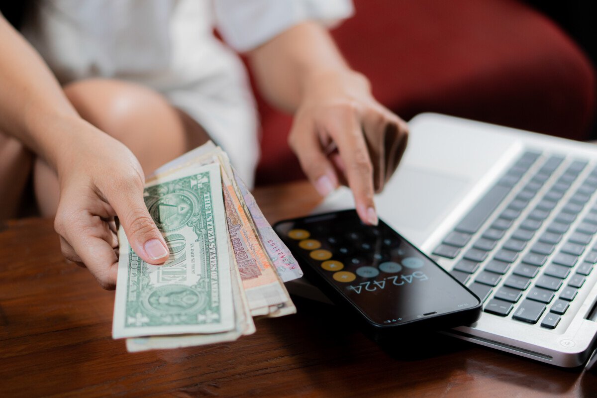 Young woman checking bills, taxes, bank account balance and calculating credit card expenses