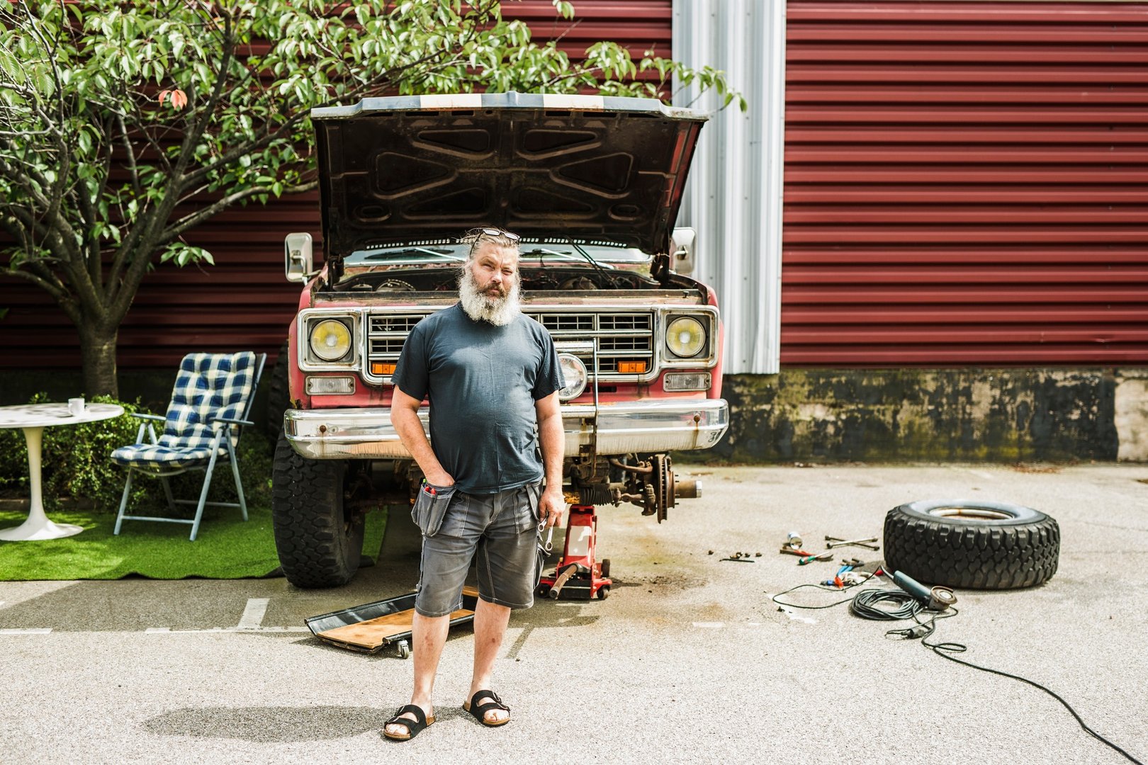 Portrait of mature man repairing truck in driveway