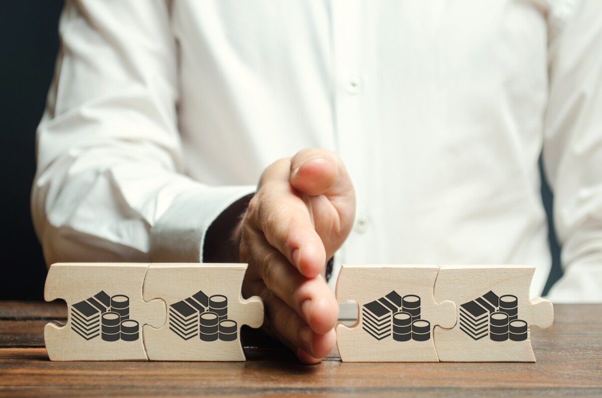 Businessman separates the wooden puzzle with a picture of money