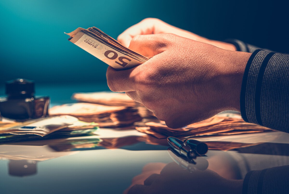 Business Owner Making Accounting and Euro Money Counting. European Market and Economy Theme.