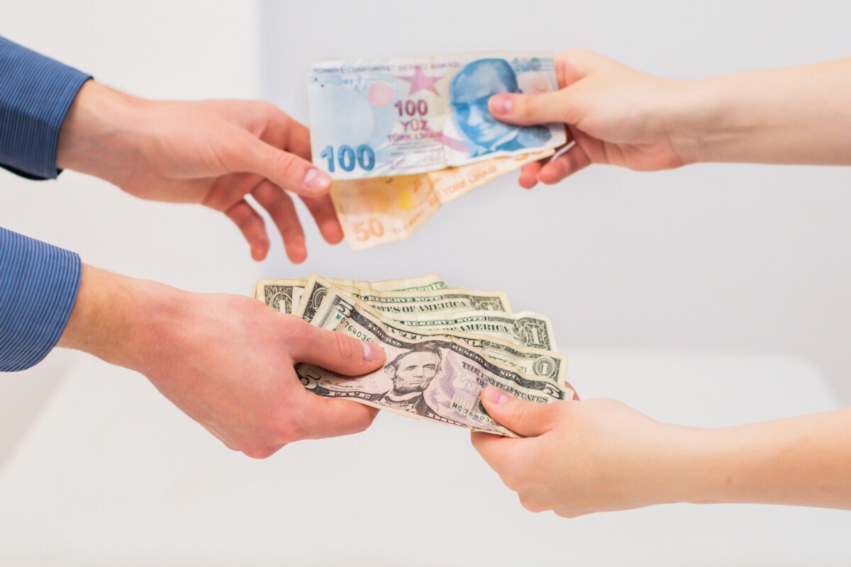 Hands women and man exchanging Turkish lira and dollar banknotes in a financial transaction. Currency exchange. Exchange…