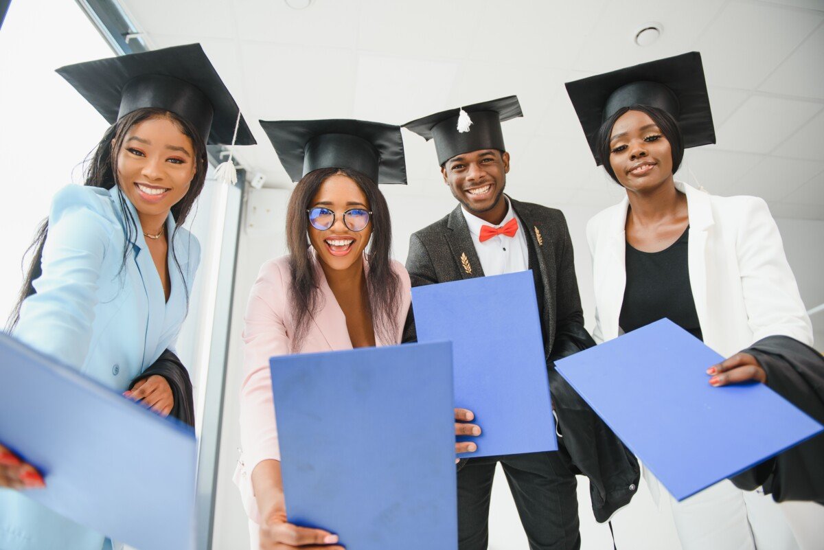 portrait of multiracial graduates holding diploma