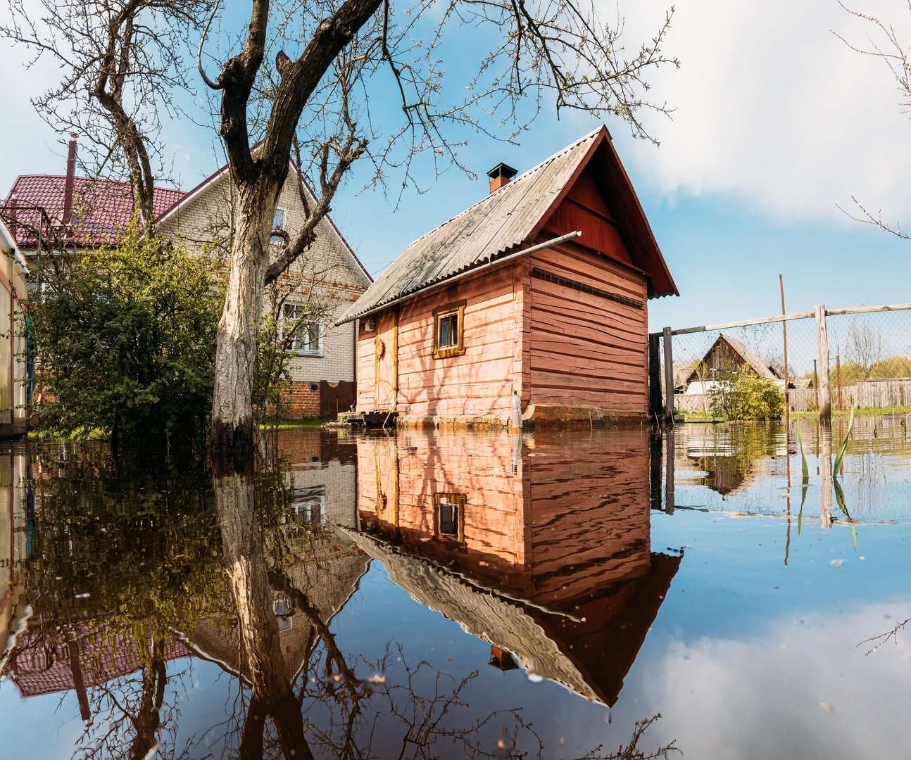 Old wooden Sauna bath building In Water During Spring Flood floodwaters during natural disaster. Water deluge During A…