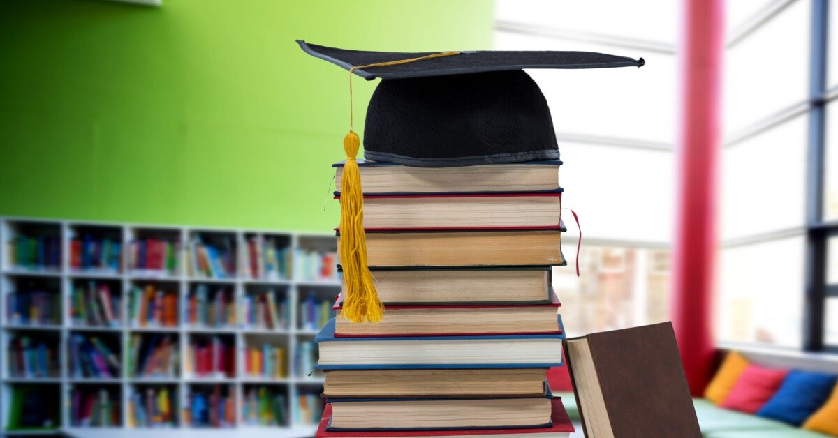 Digital composite of Books and graduation hat in education library