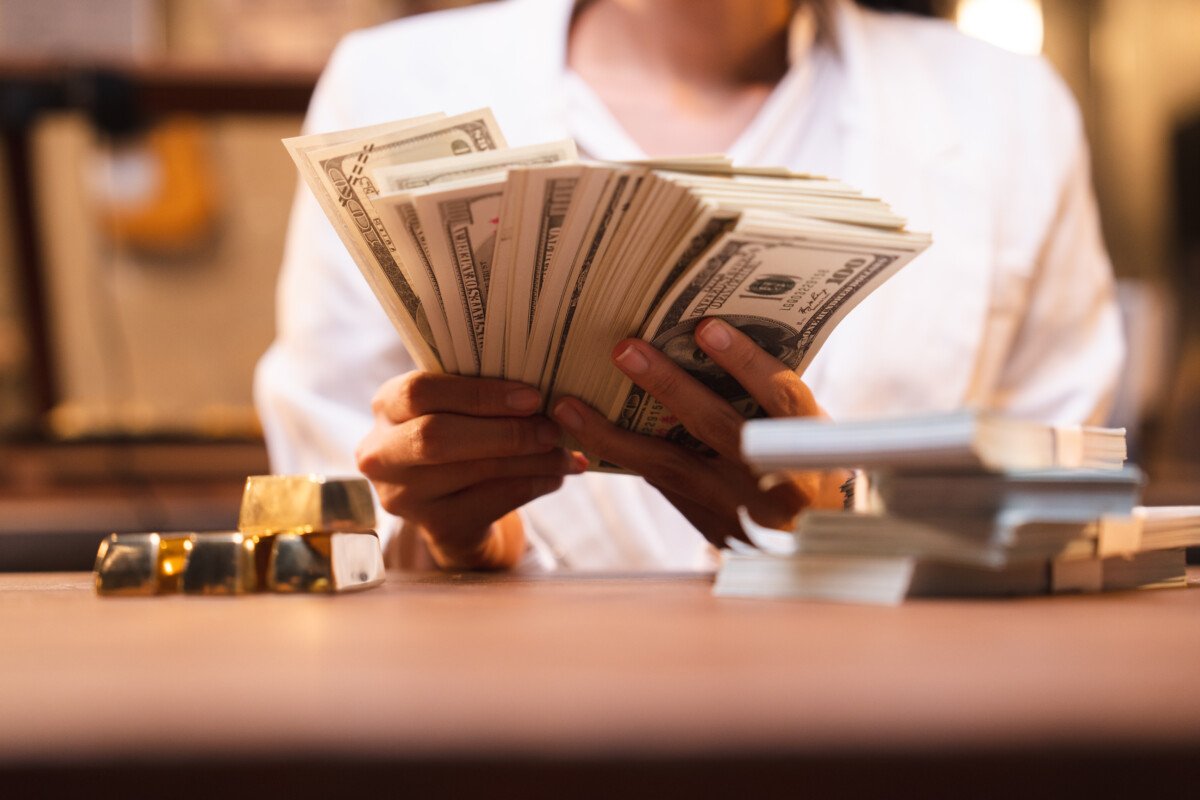 People holding money in hand to receive a lot money from trading, Business success concept, woman hand holding 100 dollar…