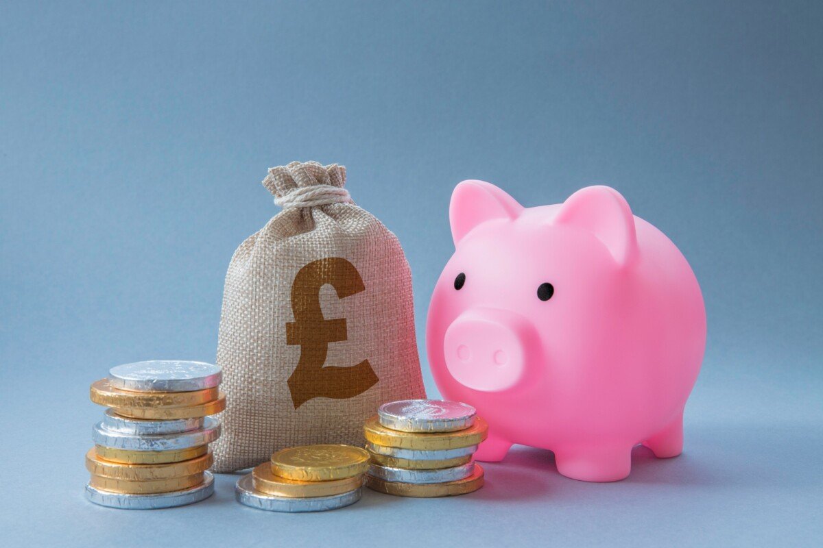 Home finance concept of family savings account with cash, money and pink piggy bank with copy space