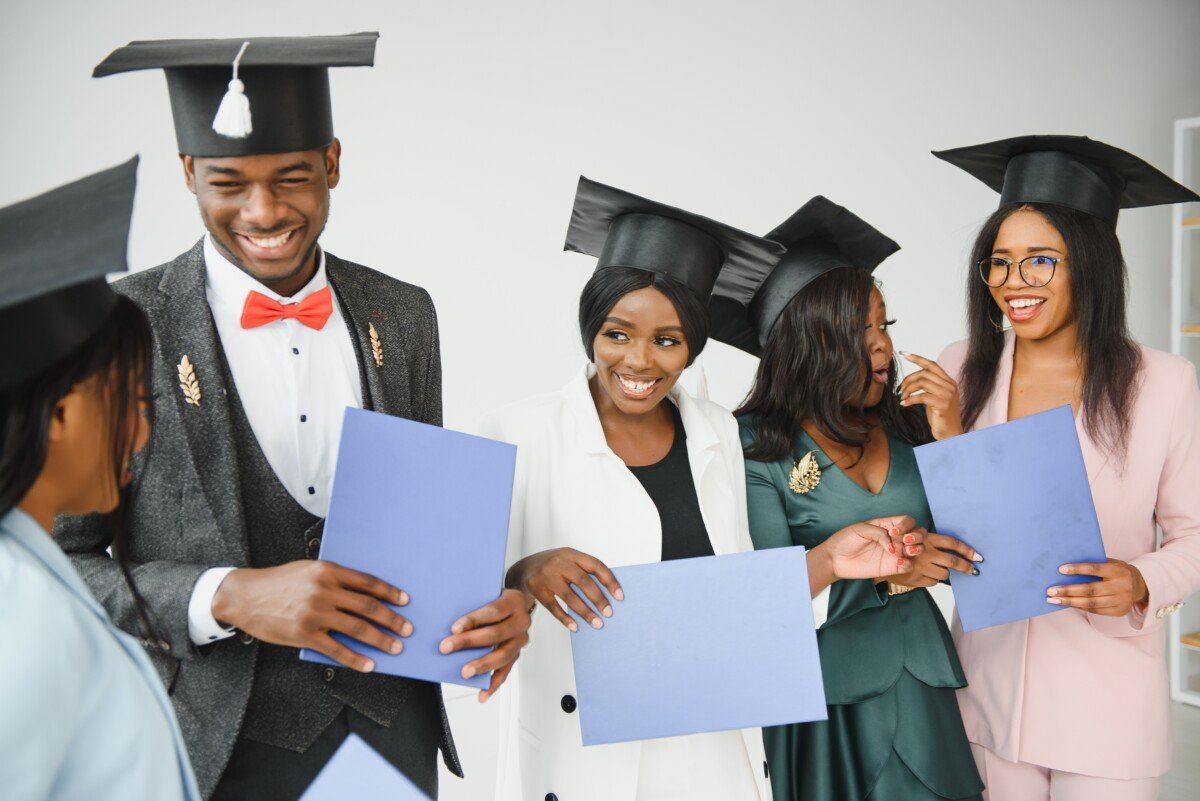 portrait of multiracial graduates holding diploma
