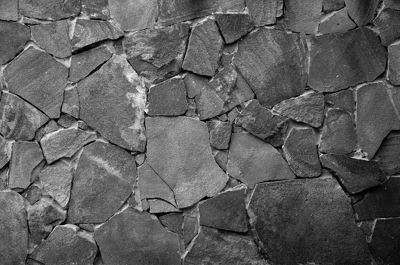Stone wall background - building feature. Texture of thick and strong wall of rough stones