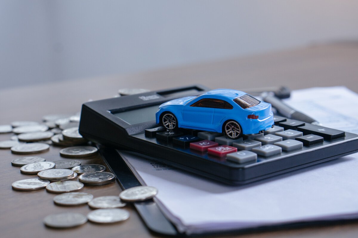 The concept of saving money. Saving money to buy a car and repairs.Miniature car model,calculatorand Financial statement…