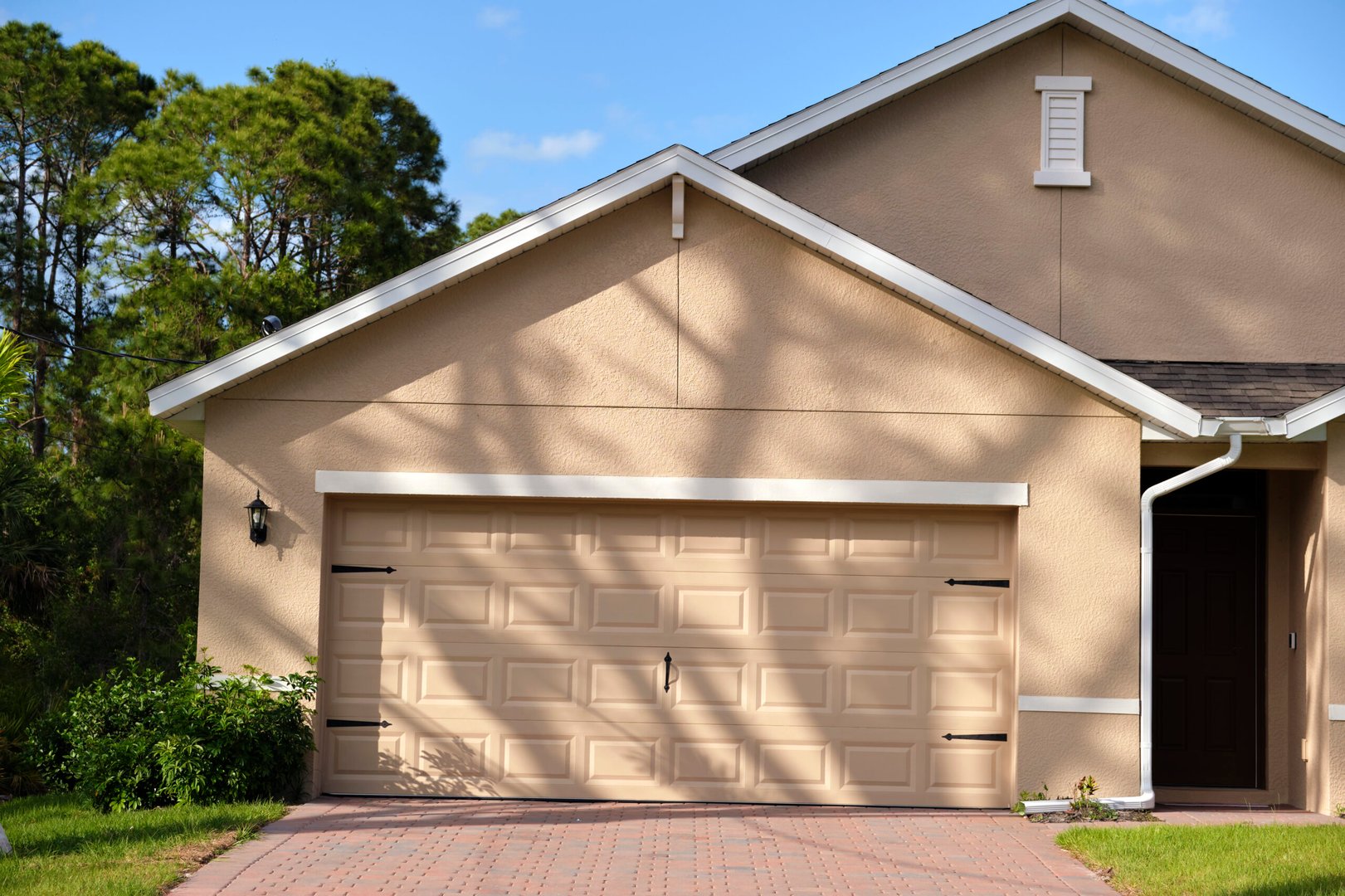 Wide garage double door and concrete driveway of new modern american house.