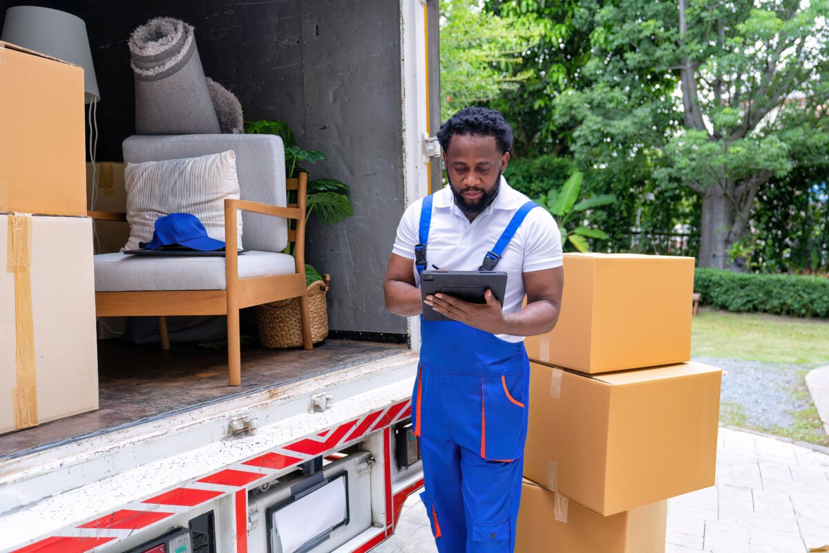 Delivery house move cargo truck service man checking box list from digital tablet for signature