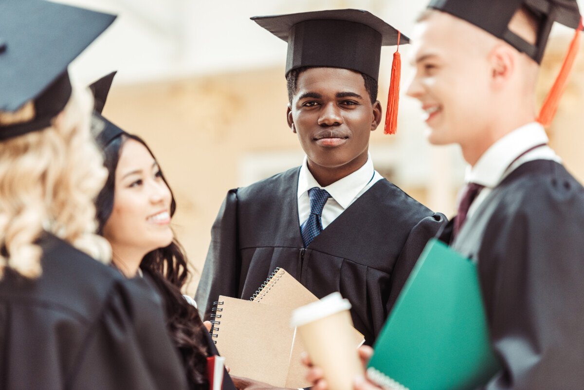 group of happy graduated multiethnic students spending time together