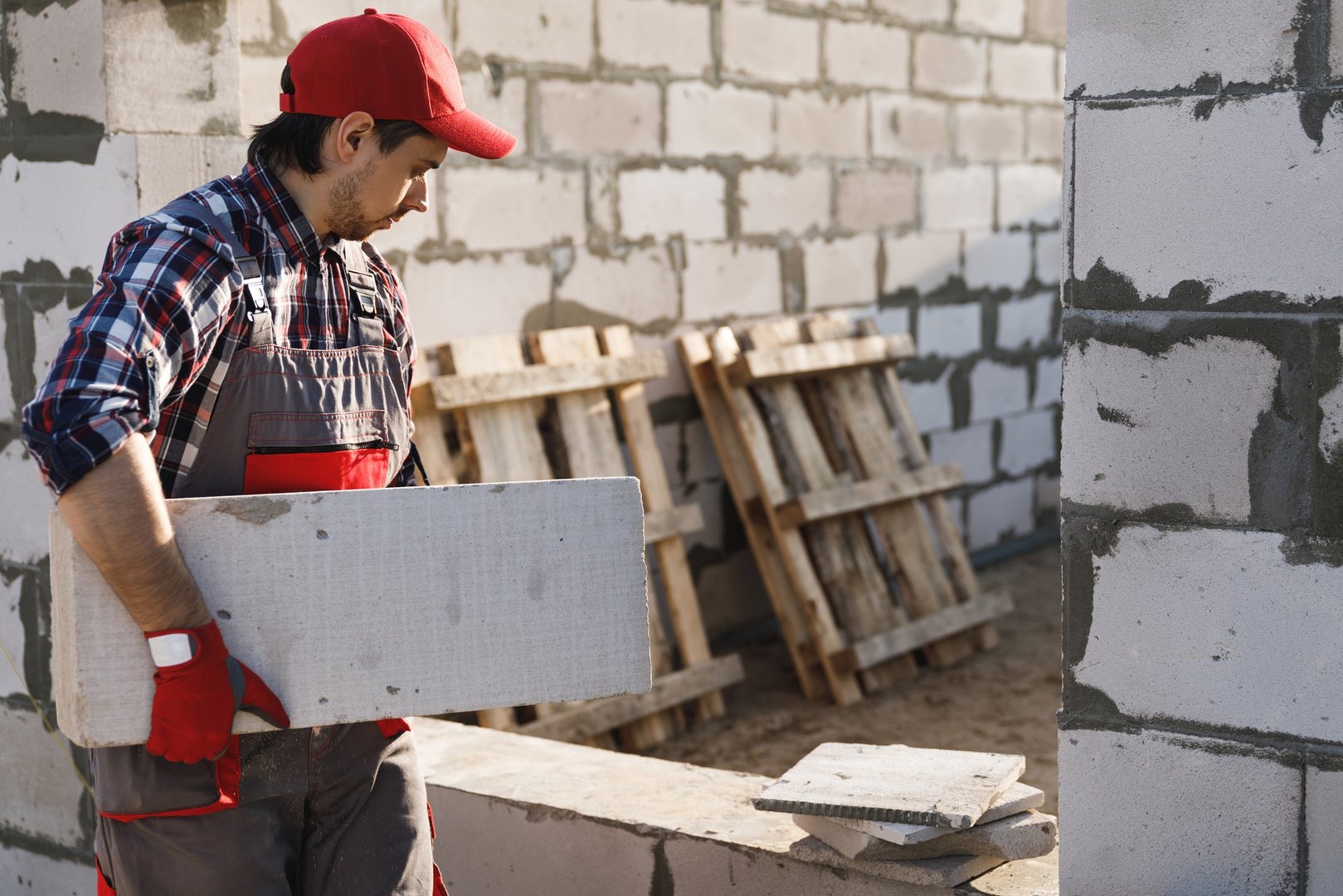 Bricklayer is working at the construction site