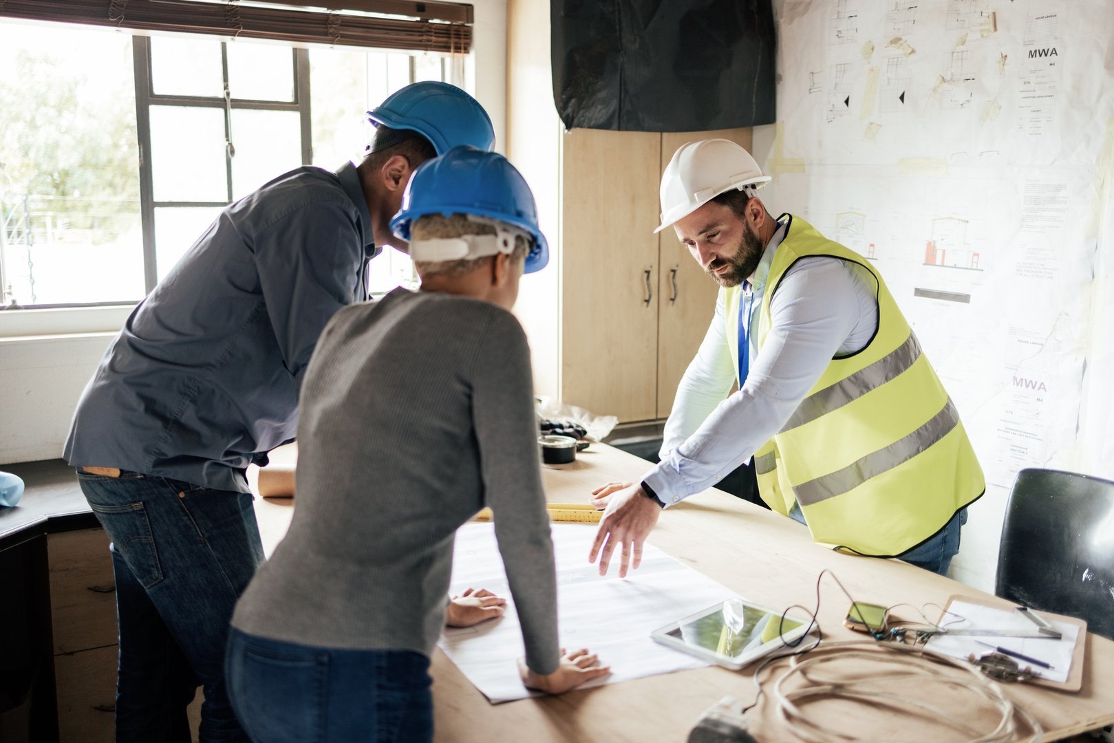 Construction workers, teamwork collaboration and blueprint planning in house, home or office buildi
