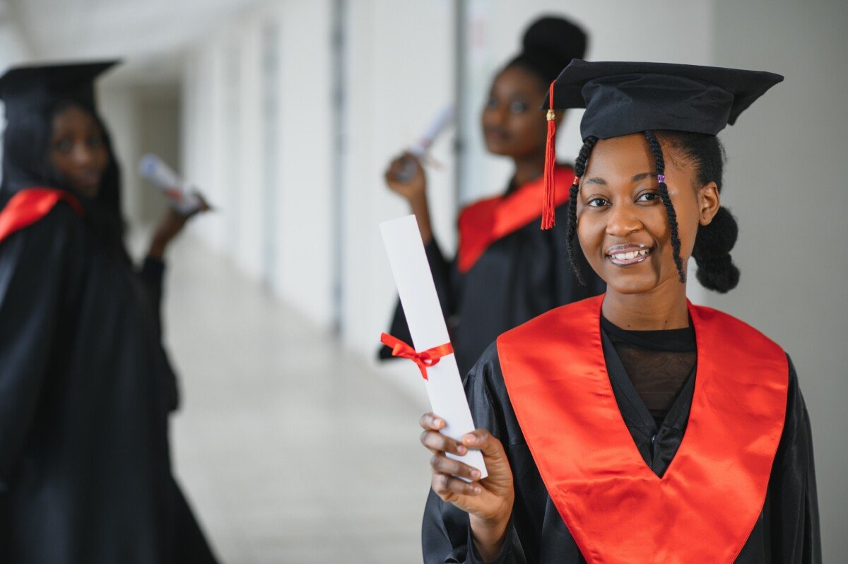 portrait of multiracial graduates holding diploma