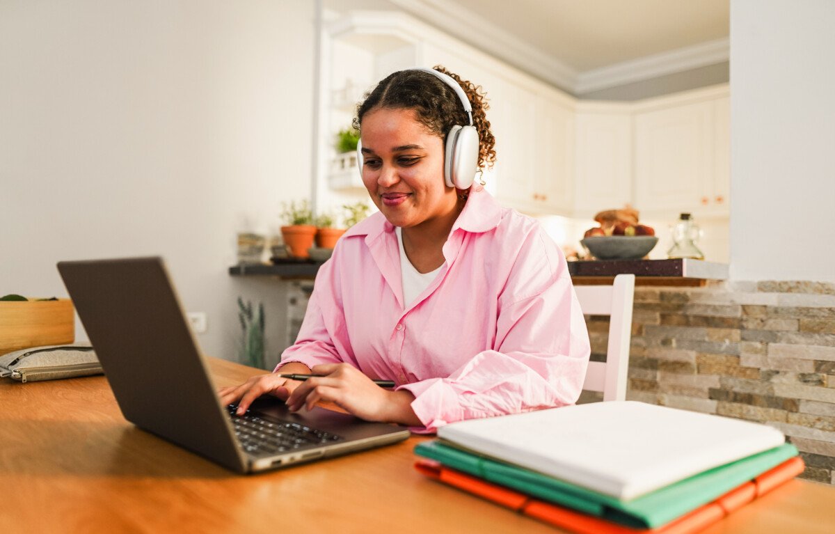 Girl using laptop computer from home while studying at college homework project – Back to school and lifestyle…