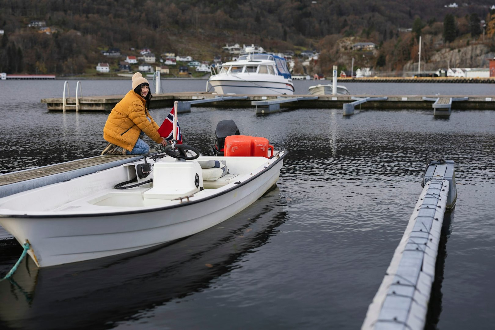 Woman in Winter Jacket Docking Boat in Quiet Norwegian Marina
