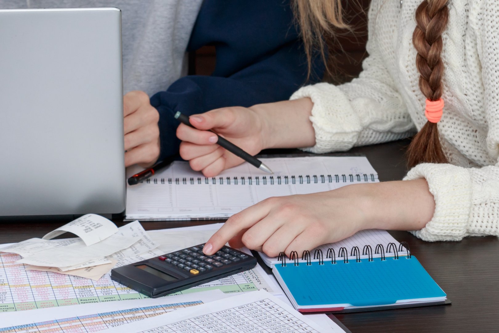Woman's hands counting expenses on a calculator closeup