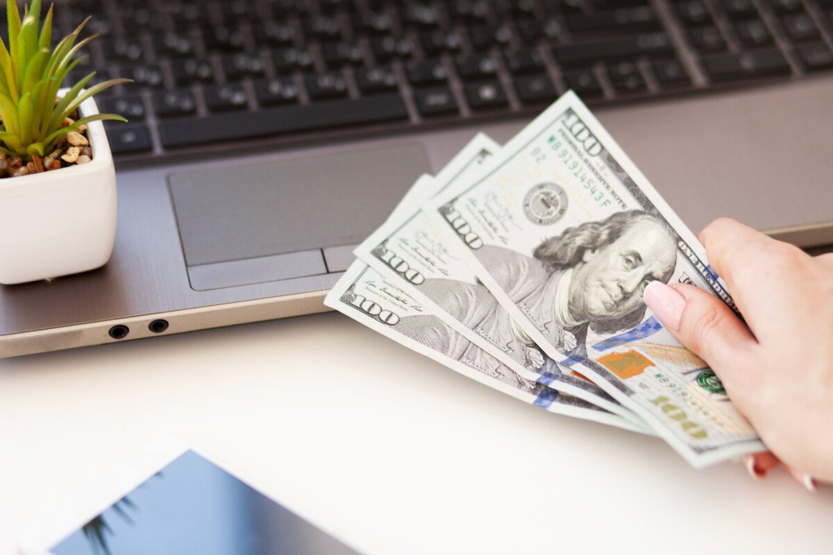 Close up of woman hand counting US Dollars.