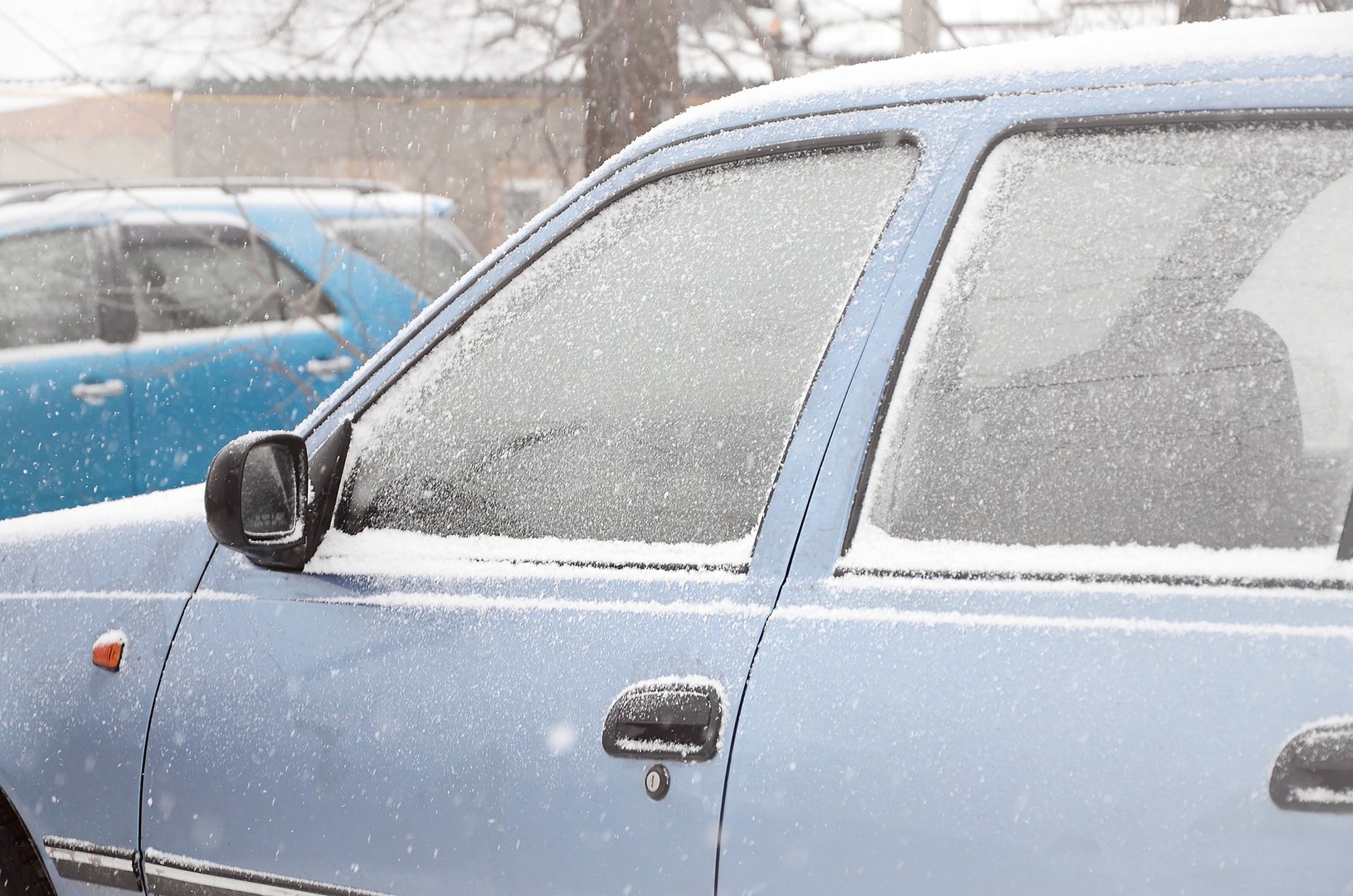 Fragments of parked cars covered with snow