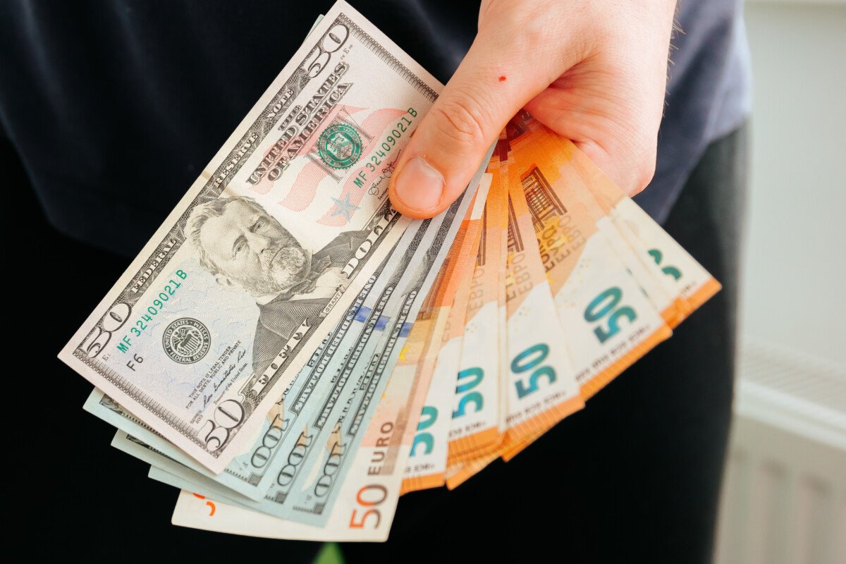 hands showing euro and dollars banknotes. Finance and business concept. Counting holding and showing money or giving money…