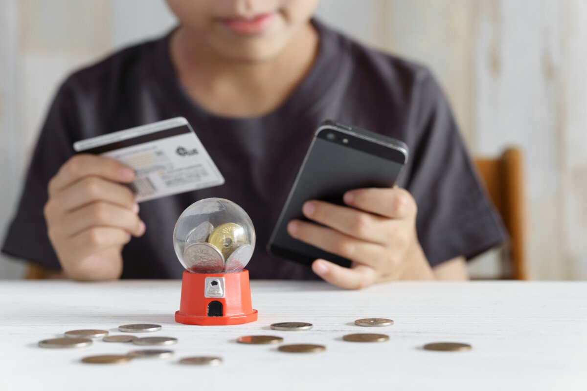 A Japanese elementary school boy tries to charge for a smartphone game with his credit card