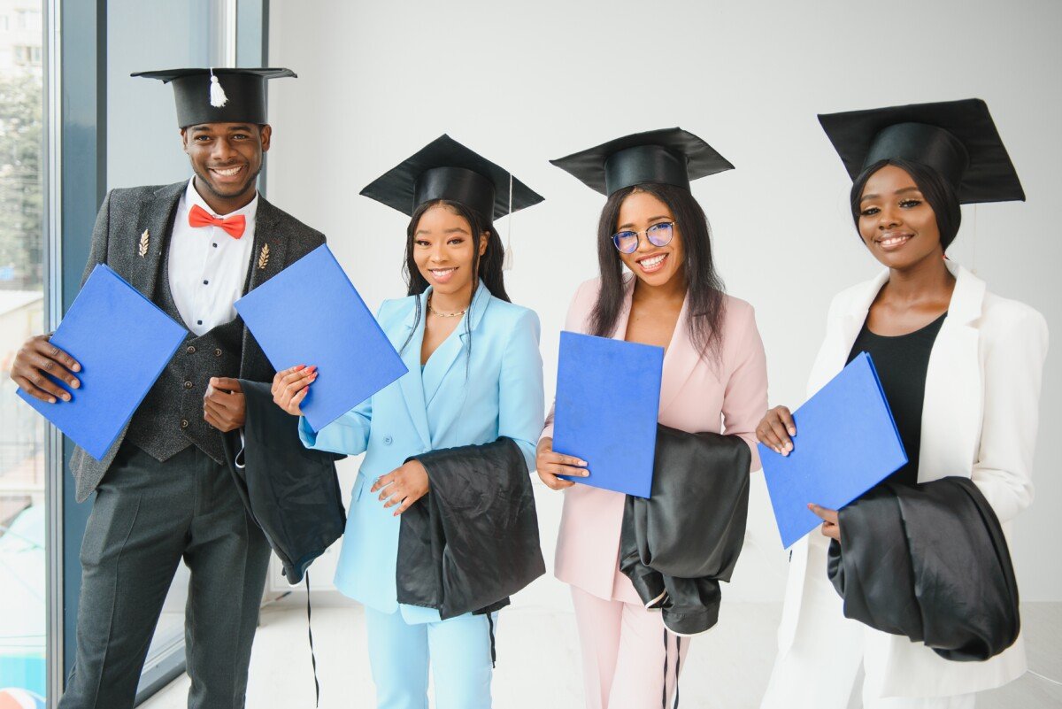 portrait of multiracial graduates holding diploma